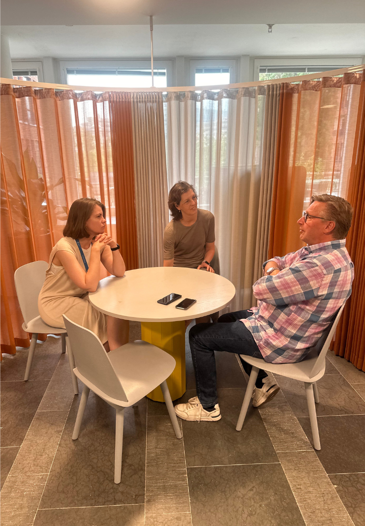 Three project participants sitting and discussing 